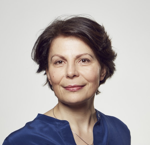 Catherine Bryan smiling wearing a blue shirt