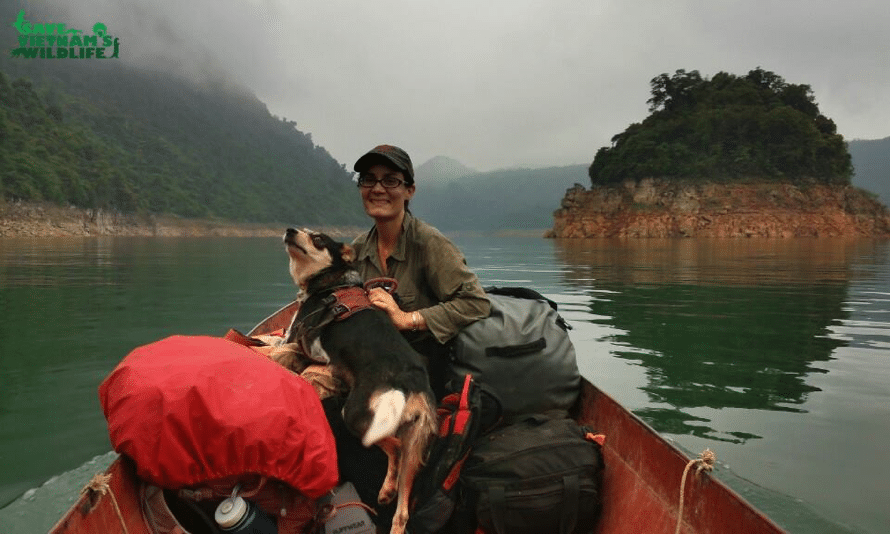 a person with a dog on a canoe