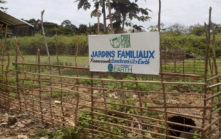 A fence made of thin wood with a sign attached.