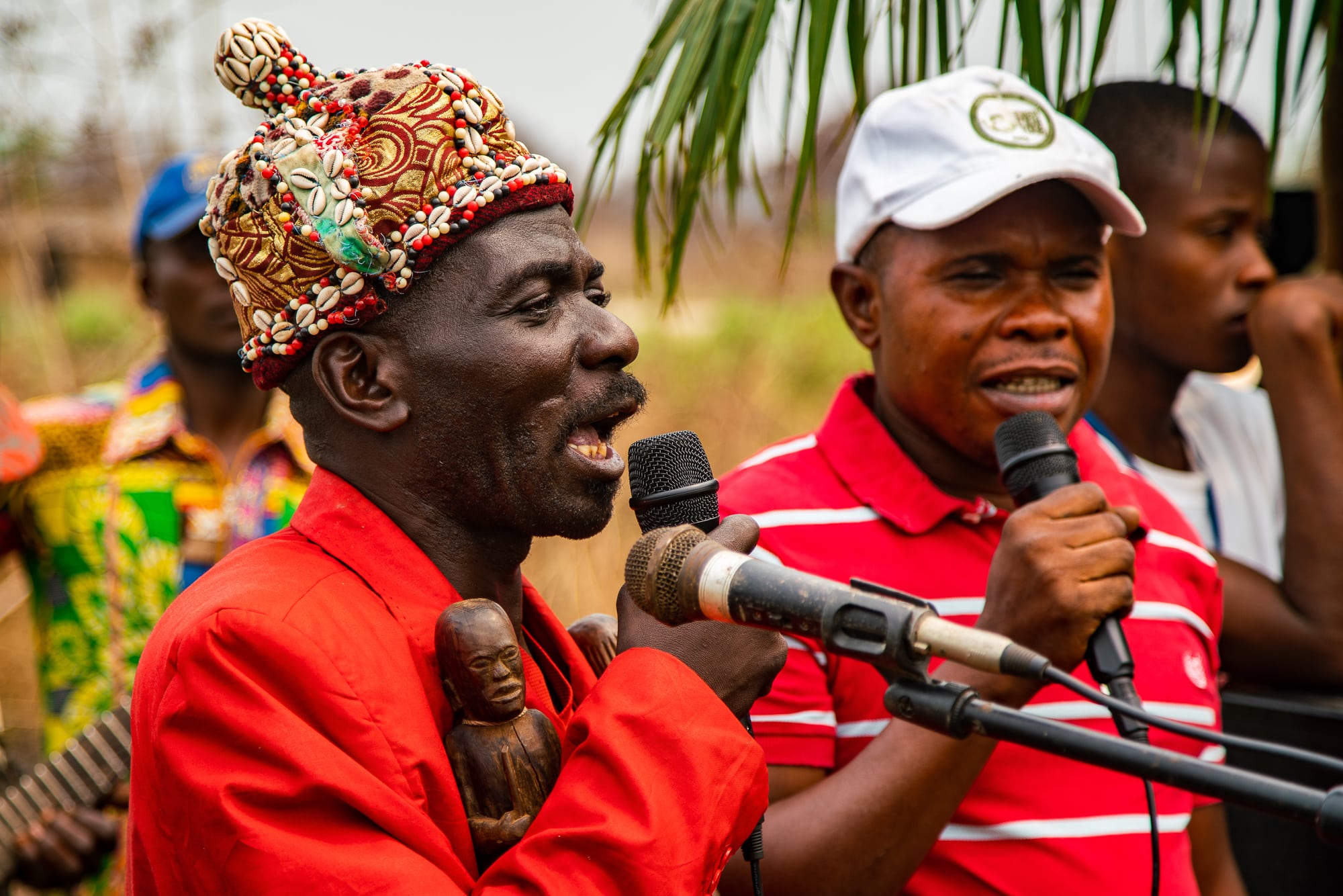 Two men speaking into microphones.