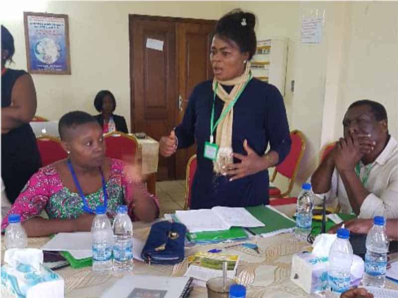 A woman speaking to a group of people.