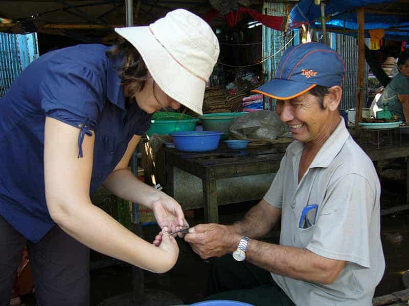 Two people work together on DNA sampling