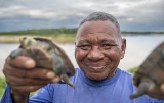 Smiling man holds torsoises