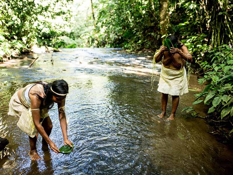 Members of the Waorani in river