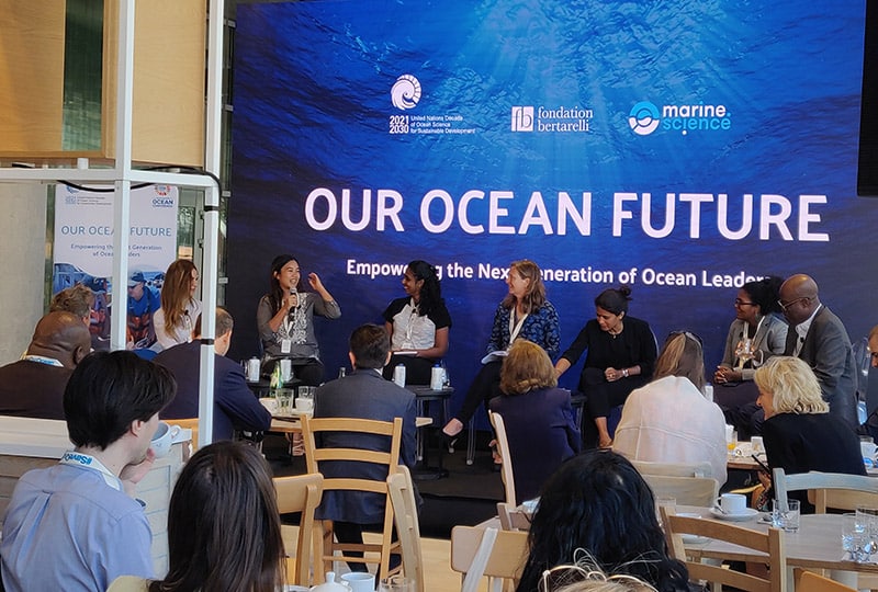 A panel speaking below a slide reading 'Our Ocean Future'