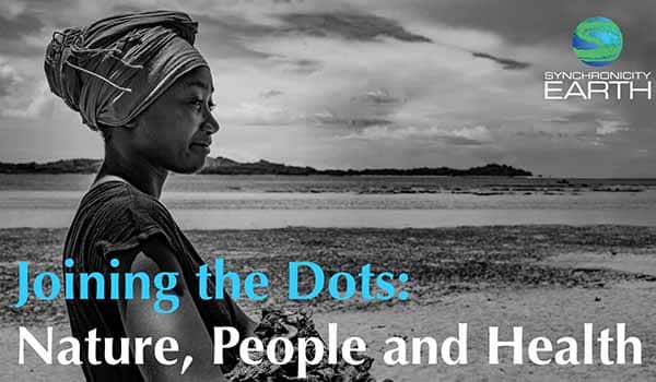 black and white poster of a person reading 'joining the dots' in blue writing and 'nature, people and health' in white