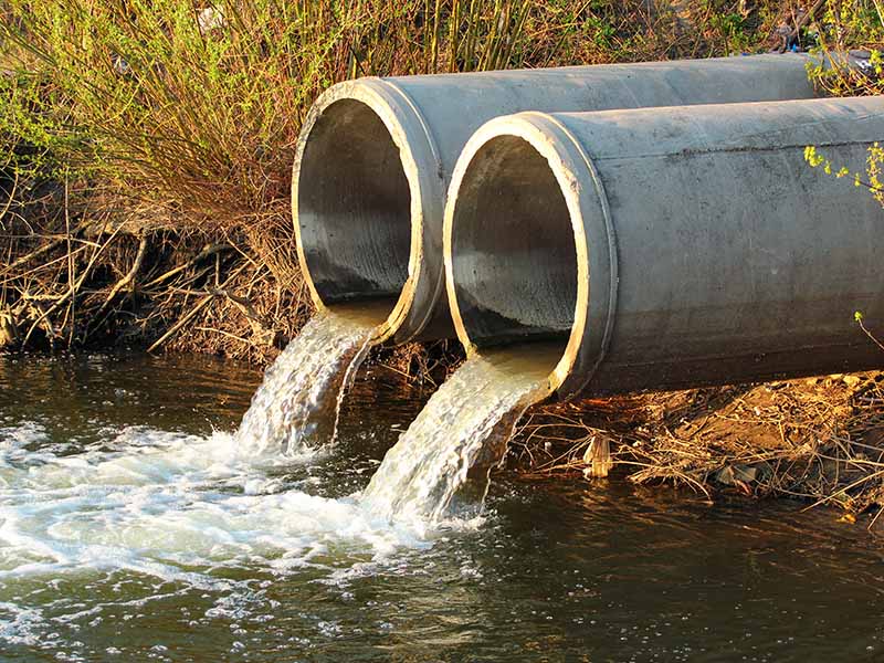 Water pipes discharging sewage into a river