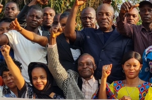 A group of people celebrating with their fists in the air.