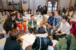 Groups of people in a workshop to prevent and respond to sexual harassment.