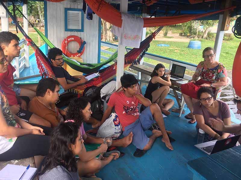 Grace Iara Souza co-teaching a group of university students on a boat on the River Negro in Amazonas, 2018