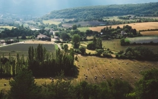 A valley landscape of fields, trees, and houses