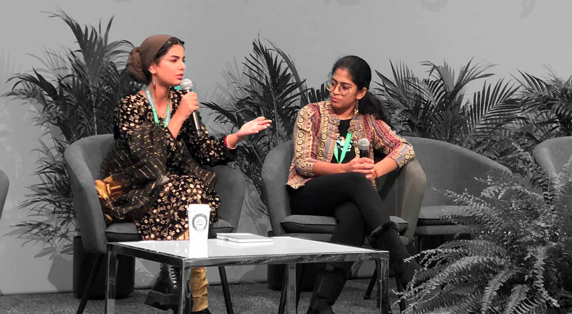 Two young women, Ayisha Siddiqa and Swetha Stotra Bashyam speaking on stage at the UN CBD COP 15 in Montreal, Canada, in 2022