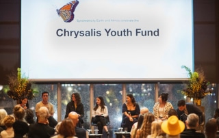 A panel of people sitting underneath a screen reading 'Chrysalis Youth Fund'