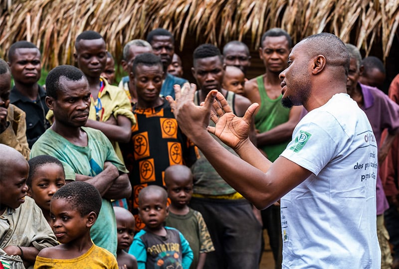 A man gives a talk to a group of people.