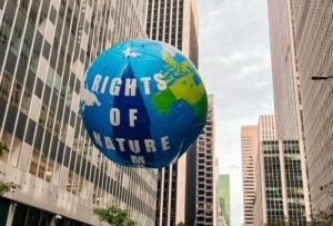 A float of the Earth that says Rights of Nature
