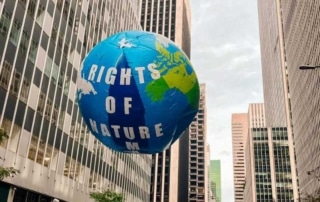 A float of the Earth that says Rights of Nature