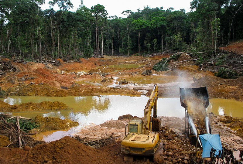 two cranes mining in a destroyed rainforest