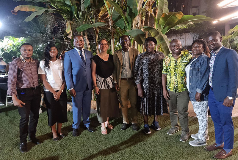 A group of Synchronicity Earth partners and staff at dinner in Kinshasa