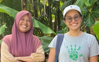 Asnim Alyoihana Lanusi (left) and Sheherazade (right) smile in front of a leafy background.