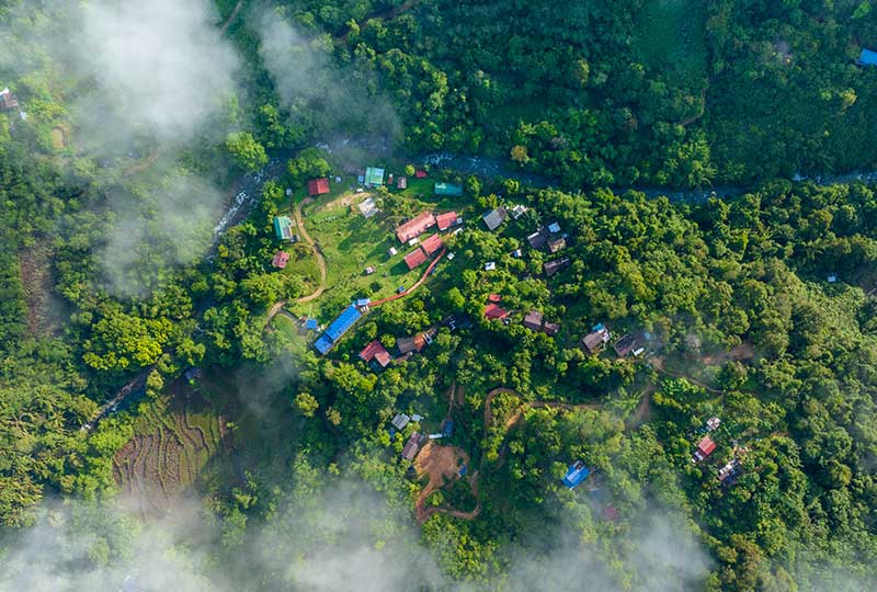 Aerial shot of village among clouds