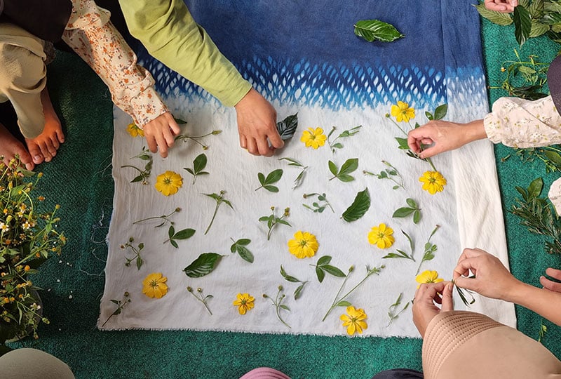 Eco printed fabric with yellow flowers and leaves