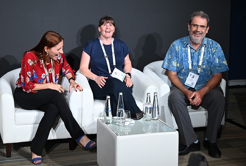 Simon laughing alongside two other speakers on a panel at the IUCN WCC