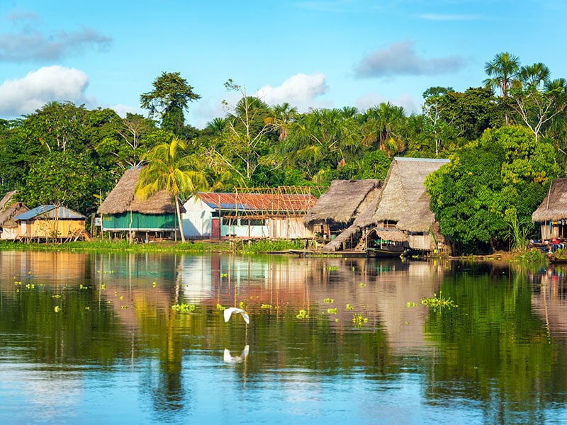 View of a small village in the Amazon rain forest on the shore of the Yanayacu River in Peru