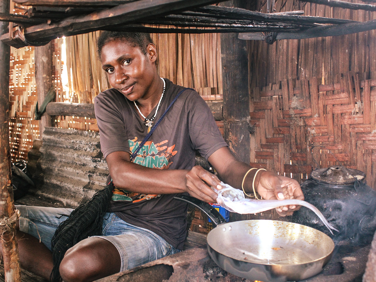 Cooking fish in PNG Someone cooking fish inside wooden hut