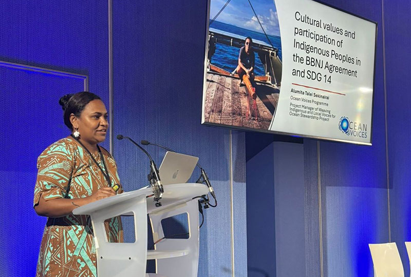 Alu Alumita presenting at a podium
