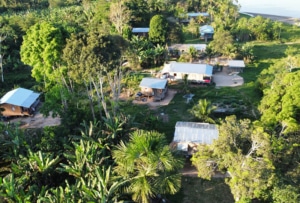 Image of community buildings surrounded by a forest.